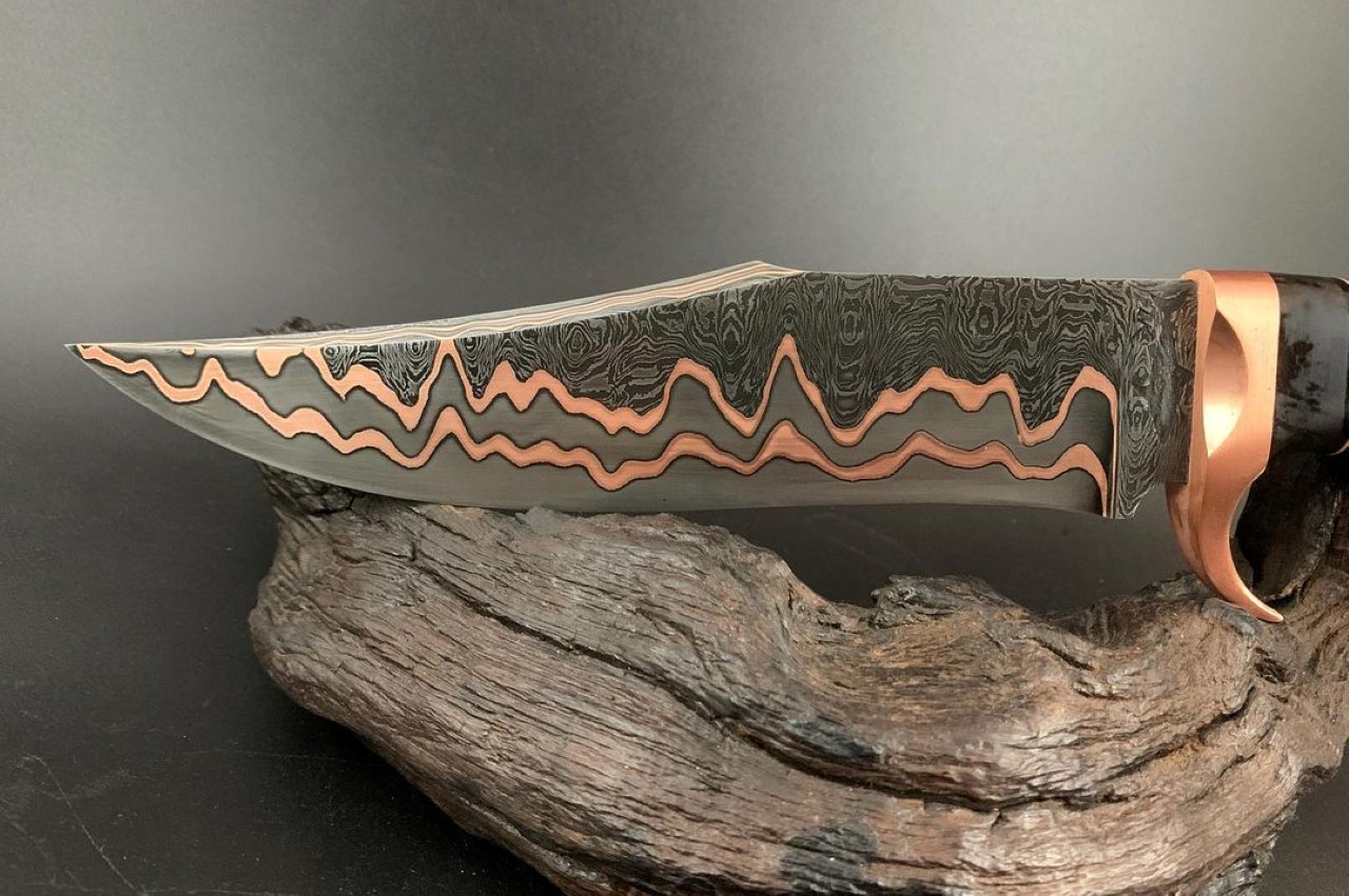 Watch how this breathtaking Copper Damascus knife is forged from