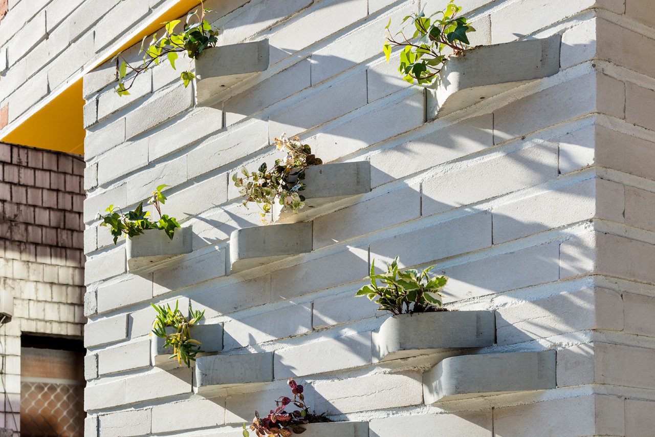 Creative brick design with a built-in planter turns the outer facade of ...