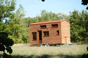 The Cosmos Tiny Home Features A Cozy Netted Upstairs Area For Reading & Chilling